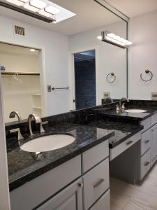 a bathroom with two sinks and a large mirror at Tennis, Greenbelt, Private Courtyard Patio in Scottsdale