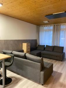 a living room with a couch and a table at Cosy Apartment in Tauplitz