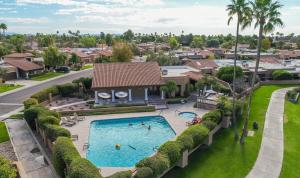 an overhead view of a swimming pool in a residential neighborhood at Waterfront, Camelback Mountain, Golf Course View N in Scottsdale