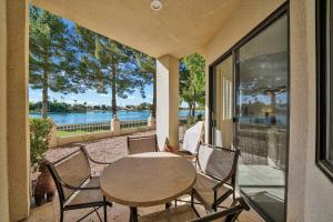 a table and chairs on a patio with a view of the water at Waterfront 1st Flr, Gated, 2 Bd Office, Trail in Scottsdale