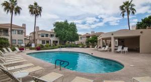 a swimming pool with lounge chairs and a resort at Waterfront Views, Office, Main Floor, Walkable in Scottsdale