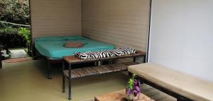 a small room with a bed on a porch at Bolita Trails and Lodging in Dos Brazos