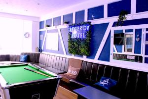 a billiard room with a pool table and a couch at The Regency Hotel in Blackpool