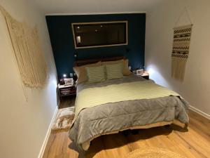 a bedroom with a large bed with a blue headboard at Viewcasavieja in Pelluhue