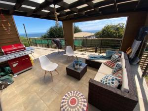 a living room with a couch and chairs on a patio at Viewcasavieja in Pelluhue