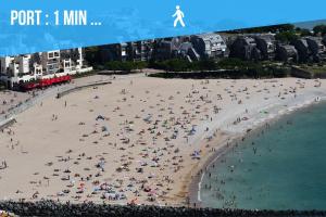 a crowd of people on a beach at Caporizon-Le Perot-T2 au coeur du vieux port 100m plage in La Rochelle