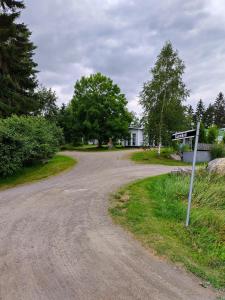 a dirt road with a street sign on it at Saarnimaja in Hämeenlinna