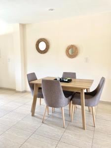 a dining room table and chairs in a room at Complejo Hermogenes in San Juan