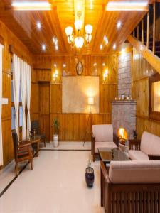 a large living room with a fireplace and a screen at The Manora Woods Resort - Private Hill Top, Gethiya, Nainital in Nainital