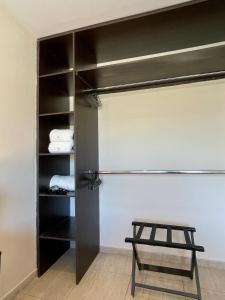 a closet with a black door and a stool at Complejo Hermogenes in San Juan