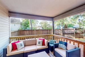 a screened in porch with two chairs and a table at Anchors Away Abode in Annapolis