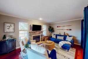 a living room with blue furniture and a fireplace at Anchors Away Abode in Annapolis