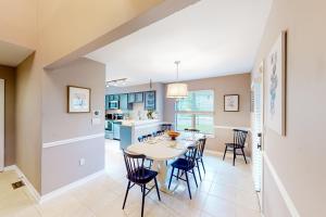 a kitchen and dining room with a table and chairs at Anchors Away Abode in Annapolis