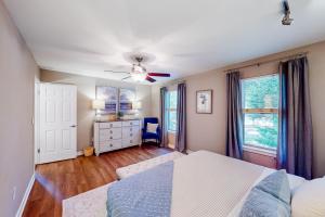 a bedroom with a bed and a ceiling fan at Anchors Away Abode in Annapolis