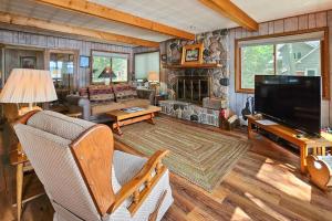 a living room with a tv and a couch and a fireplace at Artist's Cove in Manitowish Waters