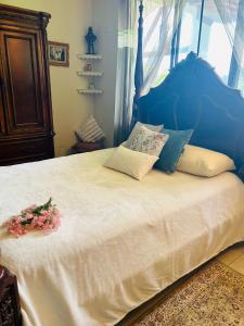 a bedroom with a large bed with flowers on it at Luxurious private room with bathroom in mountaine in Sorá