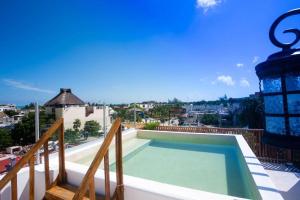 a swimming pool on the balcony of a house at La HouseFina ground floor 1 in Holbox Island