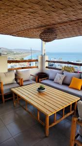 a living room with a couch and a table at BigBlue Hostel - Taghazout in Taghazout