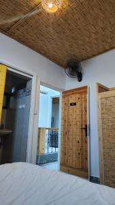 a bedroom with a bed and an open door at BigBlue Surf Experience Hostel in Taghazout +31 photos