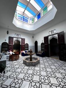 Traditional Riad in Rabat في الرباط: غرفة كبيرة فيها نافورة في منتصفها