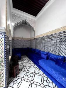 a living room with a blue couch in a room at Traditional Riad in Rabat in Rabat