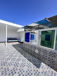 a house with a tiled floor and a building at Traditional Riad in Rabat in Rabat