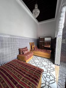 a living room with two couches and a rug at Traditional Riad in Rabat in Rabat