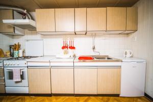 a kitchen with wooden cabinets and a white refrigerator at Holiday house in Zrnovo with terrace, air conditioning, WiFi 3709-2 in Žrnovo