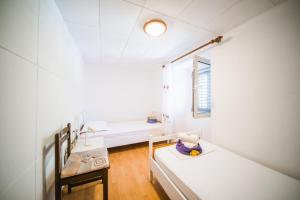 a white room with two beds and a window at Holiday house in Zrnovo with terrace, air conditioning, WiFi 3709-2 in Žrnovo