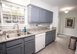 a kitchen with blue cabinets and a sink at Elegant 3 bedroom apt with free parking and balcony in Nashville