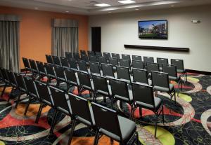 a conference room with chairs and a tv on the wall at Hampton Inn and Suites Marksville in Mansura