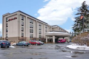 a hotel with cars parked in a parking lot at Hampton Inn Albany-Wolf Road in Albany