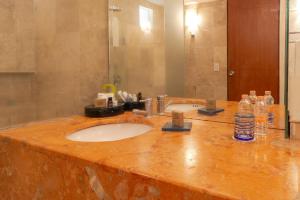 a bathroom counter with a sink and a mirror at Camino Real Guadalajara in Guadalajara
