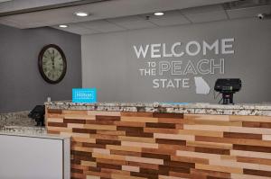 a welcome to the beach state sign on a wall at Hampton Inn Atlanta-Cumberland Mall/Cobb Galleria Area in Atlanta