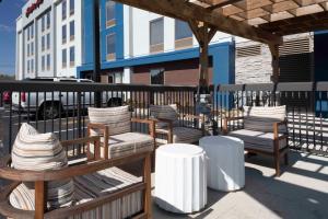 a group of chairs sitting on a patio at Hampton Inn Conyers in Conyers