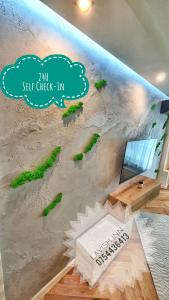 a wall in a room with a mural of a beach at Lavish Inn Apartment in Cluj-Napoca