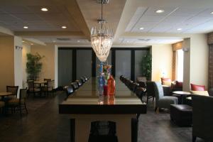 a dining room with a long table and chairs at Hampton Inn Orange in Orange