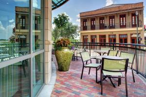 a patio with tables and chairs on a balcony at Hampton Inn & Suites Baton Rouge Downtown in Baton Rouge