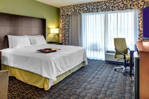 a hotel room with a bed and a window at Hampton Inn & Suites Baton Rouge Downtown in Baton Rouge