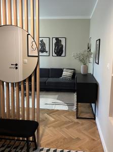 a living room with a couch and a table at Luna Apartment in Warsaw