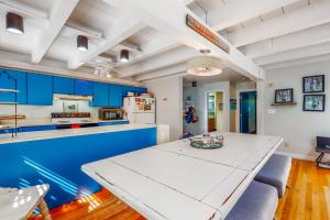 a kitchen with a white table and blue cabinets at Martha's Hideaway in Edgartown