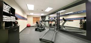 an empty gym with a treadmill and a treadmill at Hampton by Hilton in Brentwood