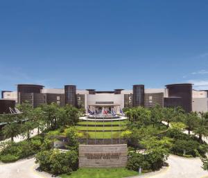 a building with a park in front of it at Thousand Cranes Sanya Yazhou Bay Int'l Exchange Centre in Sanya