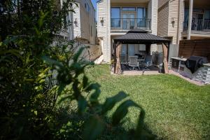 a backyard with a gazebo and a table and chairs at Casablanca 1 in Houston