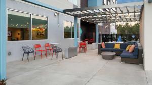 a patio with chairs and a couch and a table at Tru By Hilton Greensboro Lake Oconee, Ga in Greensboro