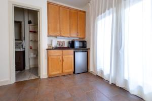 a kitchen with wooden cabinets and a refrigerator at Beautiful first floor suite with backyard, near Downtown and stadiums in Houston