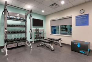 a gym with dumbbells and a simulator at Tru By Hilton Austin Nw Arboretum, Tx in Austin