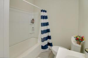 a bathroom with a blue and white shower curtain at Shelby Vacation Rental Close to Parks and Trails! in Shelby +16 photos