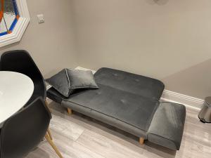 a black couch in a living room with a table at Warner's Collection in Dublin