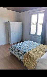a bedroom with a bed and a window at Room Marci- SweetHome in Marcinelle